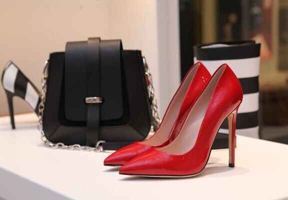 червени дамски високи обувки с ток и черна чанта